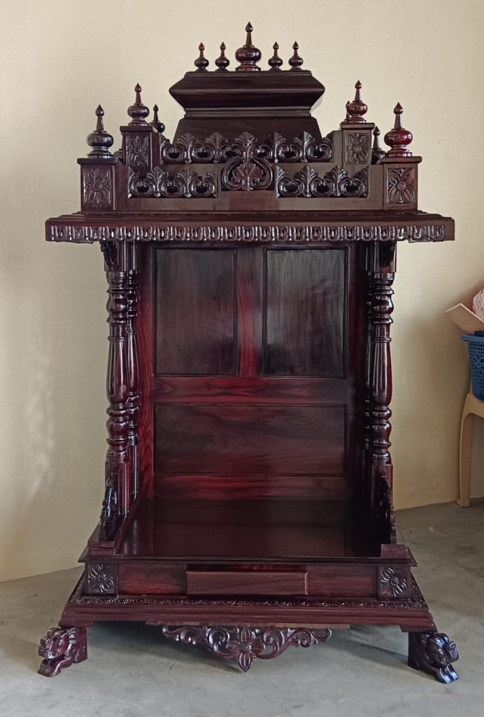 Front view of the compact pavilion, with a paneled back and carved feet