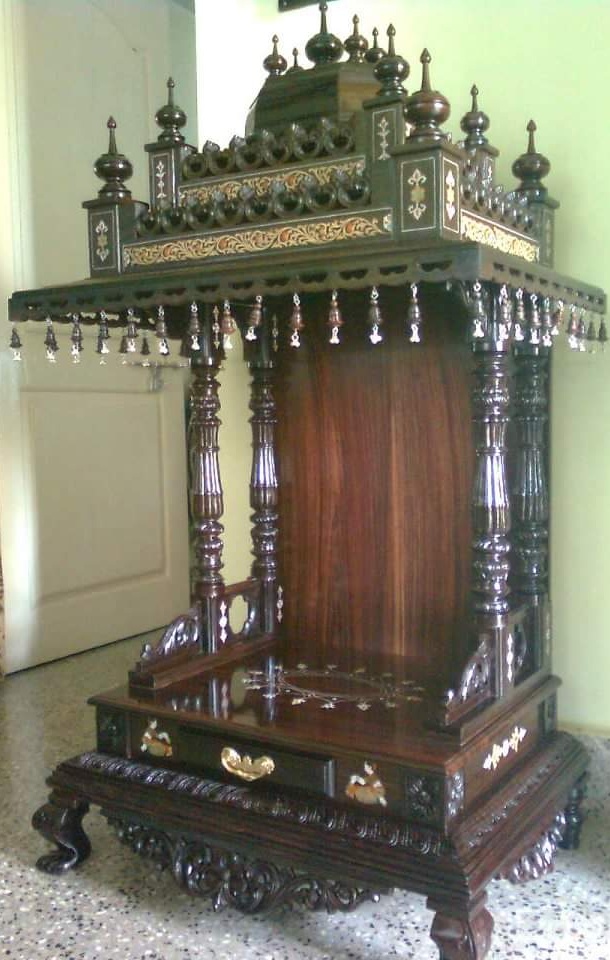 Dark rosewood pavilion with a fringe of bells and clear drops under the eave