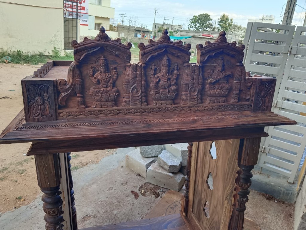 Carved rosewood frieze of Lakshmi, Ganesha, and Saraswati