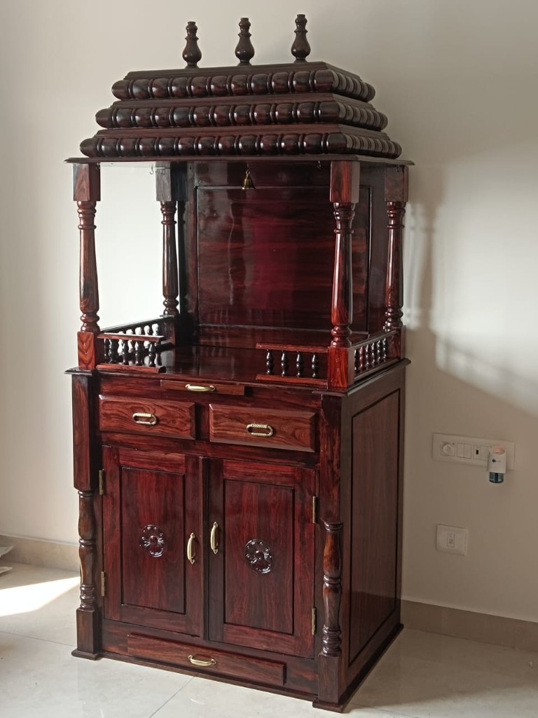 Rosewood pooja unit with a glass shrine above and cabinets below