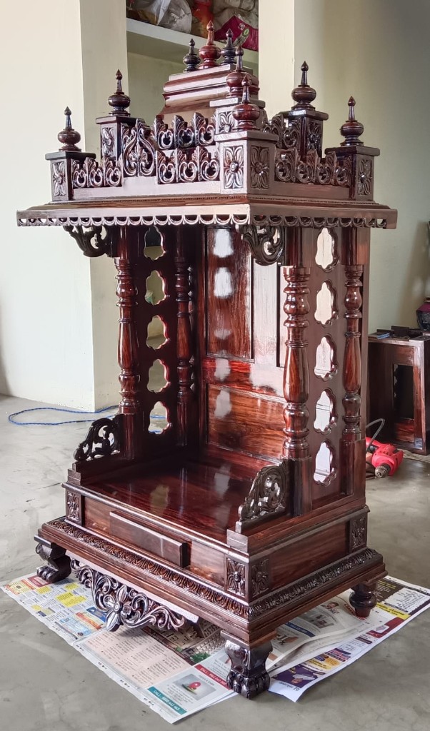 Rosewood mantapa whose pillars are pierced with oval openings