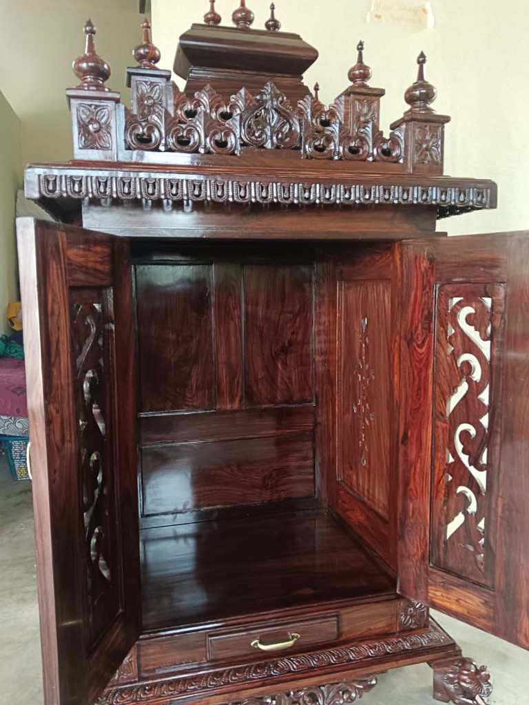 The same cabinet open, showing a polished interior and a shelf