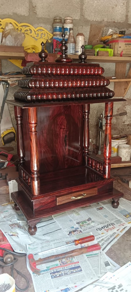 Rosewood mantapa with a stacked ribbed roof and a simple open sanctum