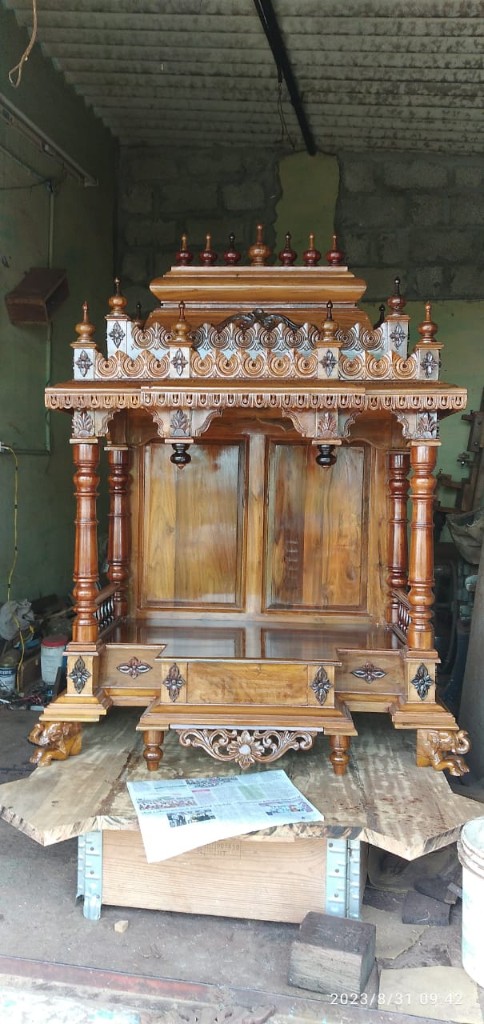 Teak mantapa with a carved crest, front step, and lion feet
