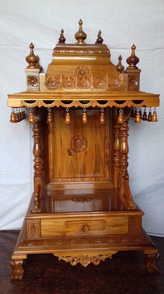 Teak mantapa with a scalloped eave and a row of hanging bells