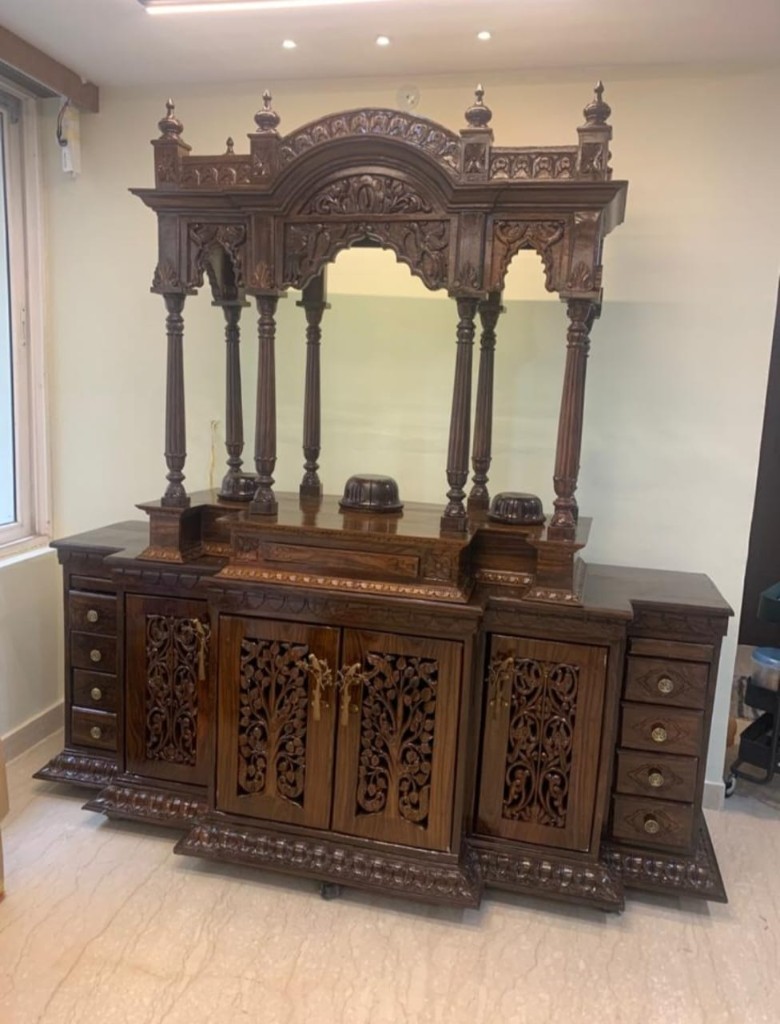 Wide rosewood wall mandir with a central shrine, mirror, and side cabinets